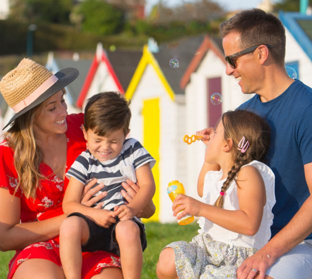 Family in front of beach huts