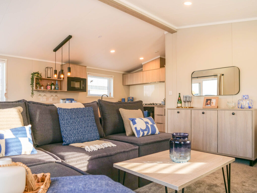 faraday living area - open plan with view of kitchen in background and hanging festoon lights.