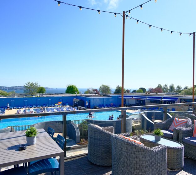 Jetty Terrace overlooking the Lagoon outdoor swimming pool with the sea in the background.