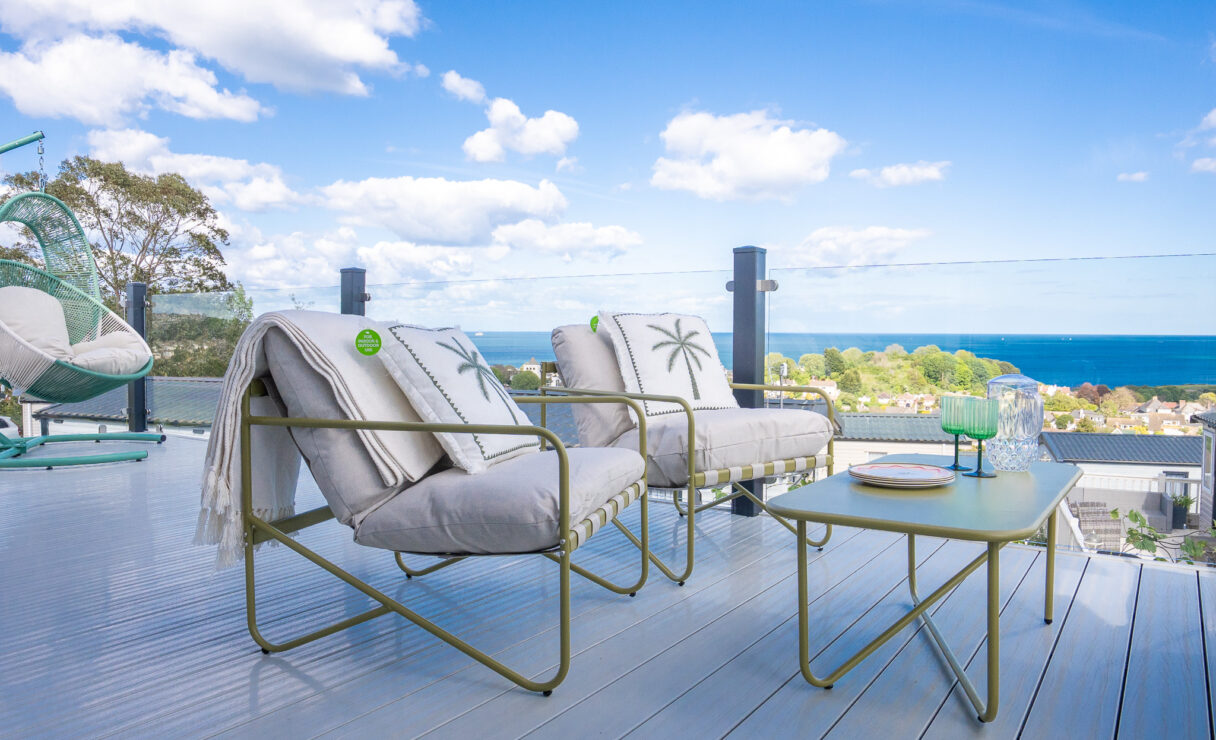 Regal Harbour luxury lodge with decking and outdoor furniture over looking the sea