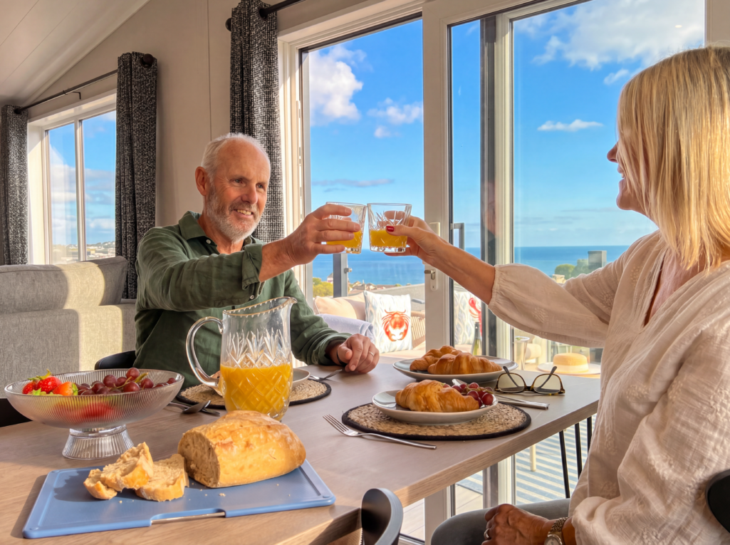 Couple eating breakfast in the Victory View luxury lodge