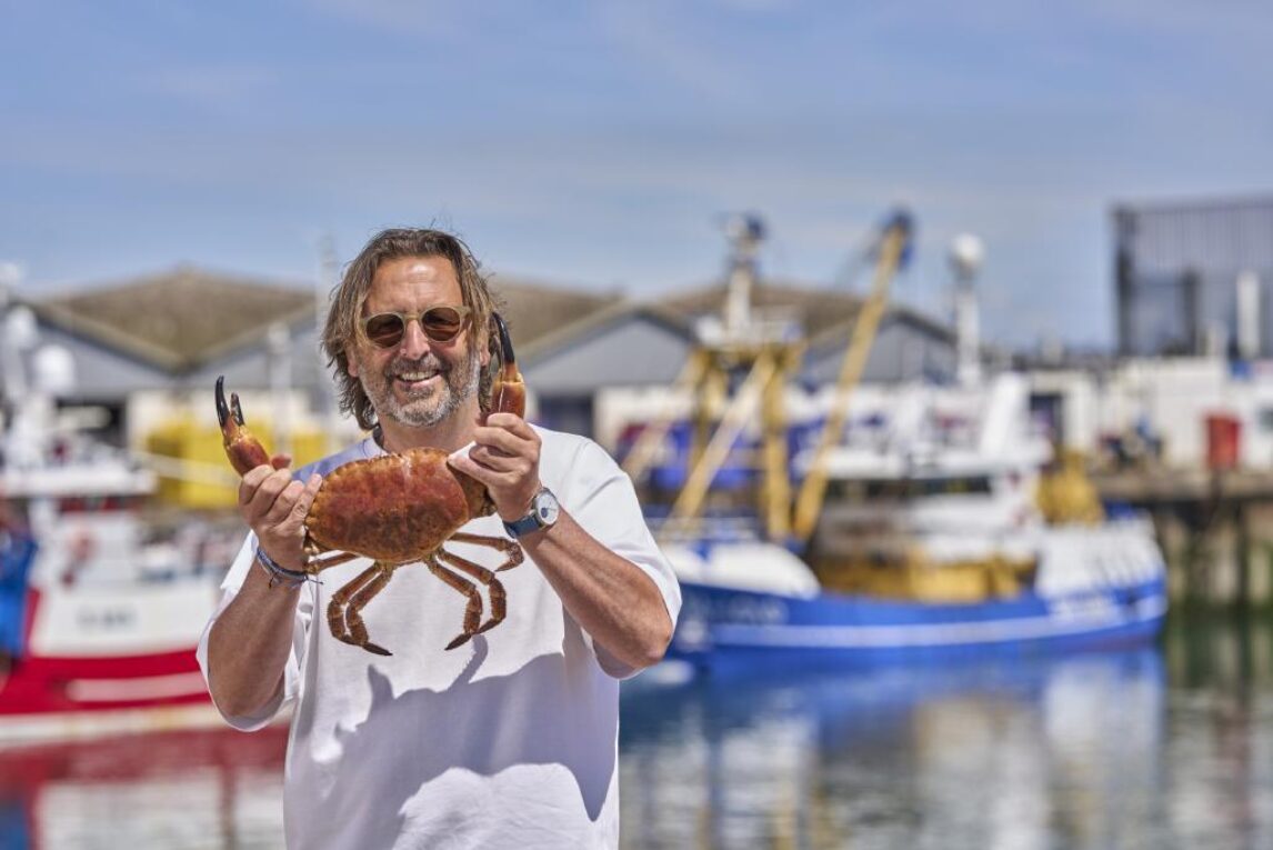 Mitch Tonks holding at crab at England's Seafood Feast.