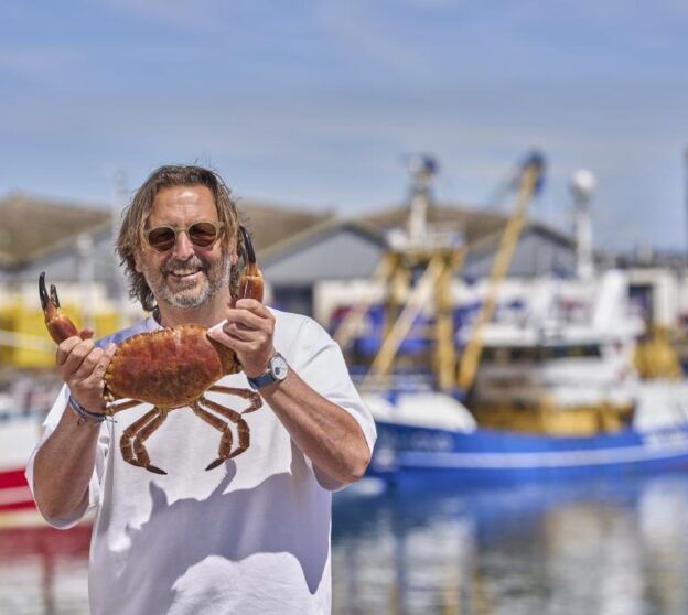 Mitch Tonks holding at crab at England's Seafood Feast.