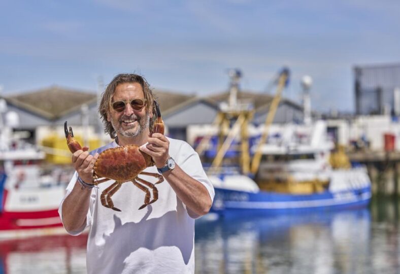 Mitch Tonks holding at crab at England's Seafood Feast.