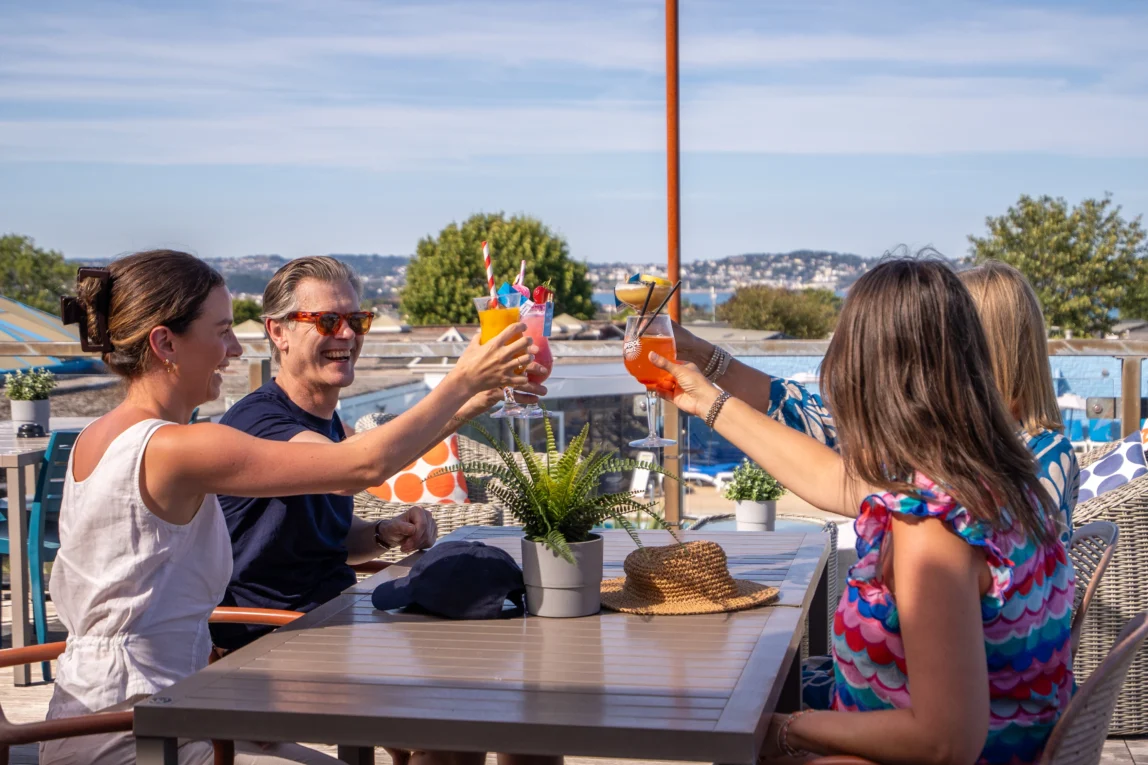Friends saying cheers with cocktails on Jetty Terrace