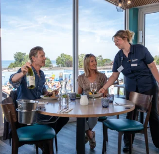 Couple being served dinner in the Jetty restaurant