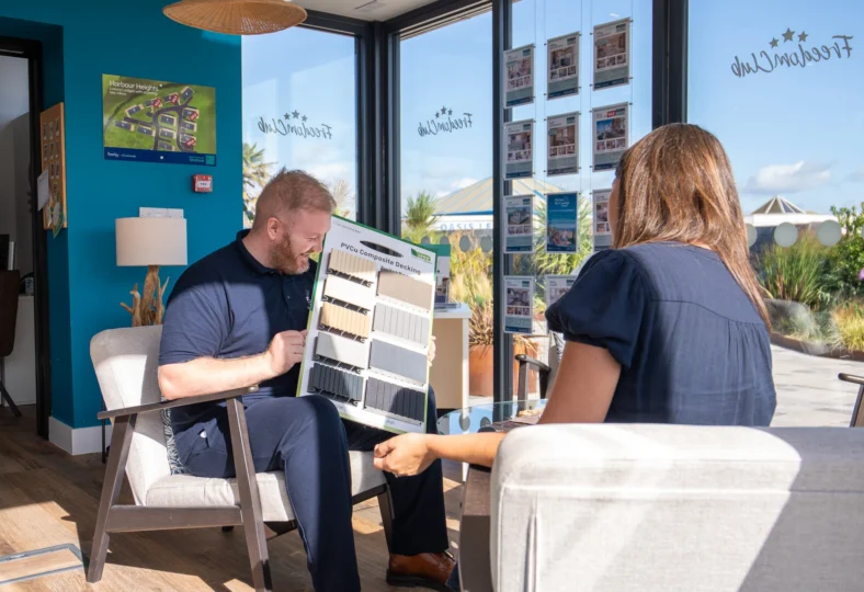 James showing a customer decking samples in The Holiday Home Sales Office on a Park Visit